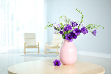 Vase with beautiful flowers on table indoors. Space for text