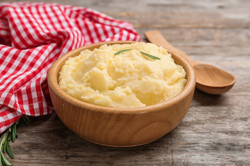 Bowl with tasty mashed potato on wooden table