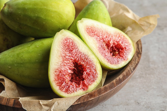 Bowl with fresh ripe figs on table, closeup