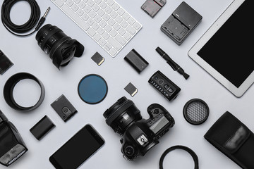 Flat lay composition with equipment for professional photographer on white background