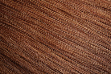 Texture of healthy red hair as background, closeup