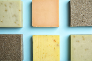 Hand made soap bars on color background, top view