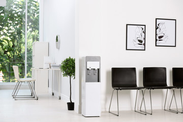 Modern water cooler in stylish office interior