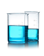 Beakers with liquid on table against white background. Laboratory analysis