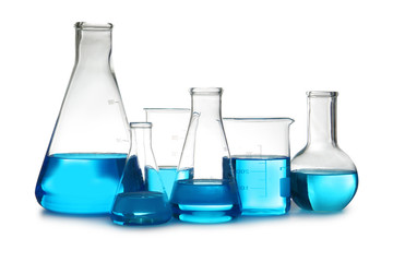 Laboratory glassware with liquid on table against white background. Chemical analysis