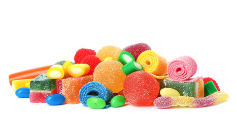 Pile of delicious colorful chewing candies on white background