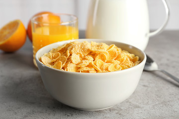 Bowl with healthy cornflakes for breakfast served on table, closeup