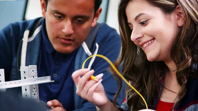 High School Pupils Building Robotic Vehicle In Science Lesson Together
