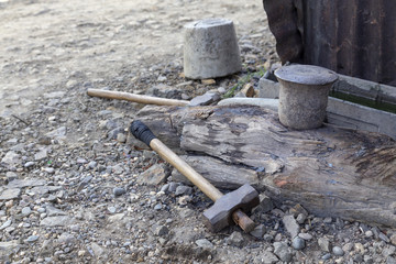 View of a hammer and a traditional Laos anvil for forging near Luang Prabang.