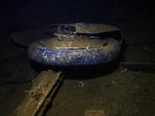 The wheel of a Japanese Mitsubushi Zero fighter in the cargo hold of a ship sunk at Truk Lagoon during World War II