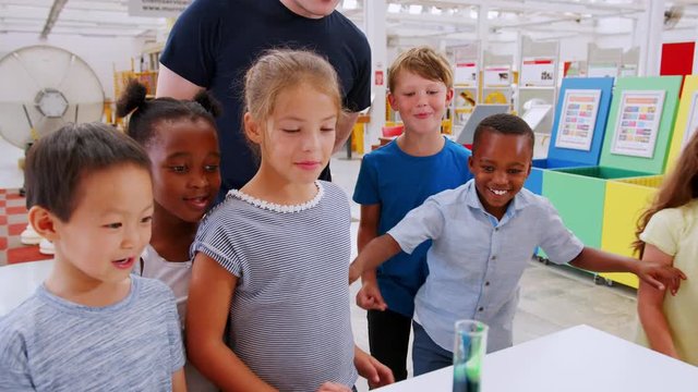 Excited children watch chemical reaction at a science centre
