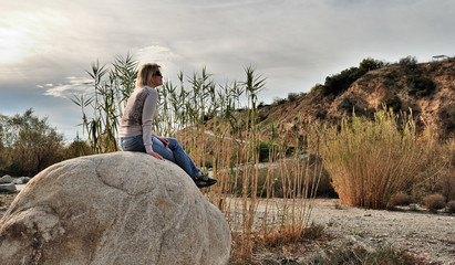 woman sitting on rock - 227375540