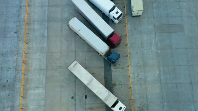 Aerial view of parked semi-trailers trucks on the logistic terminal parking lot
