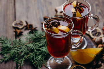 Christmas magic atmosphere, home celebration. Hot mulled wine, spices and festive natural decorations . Winter holidays celebration concept