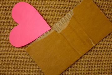 Design business concept Empty copy space modern abstract background. Torn thick paper, blood and pigment red texts, jute sack, pink paper heart