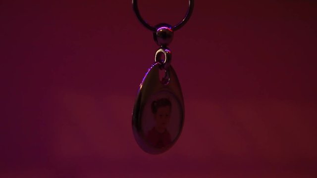 Close Up of the Hanging Child's Photo in Metal Souvenir Keychain.