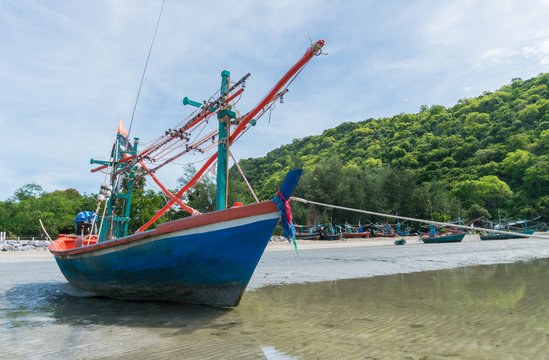 Blue Fishing Boat on Sea Sand with Green Mountain at Khao Kalok Beach Thailand