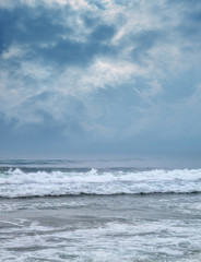 Naklejka na ściany i meble Landscape image os sea with waves over storm sky