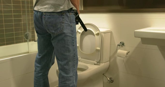 Man Prostate Difficulty Stands at Toilet Trying to Urinate