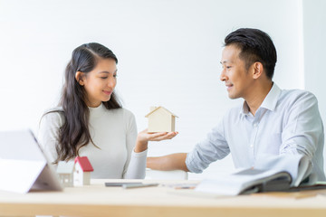 Happy couple plan buying house.Concept for Couple saving money for buy home and real estate. Select material for decorate furniture.