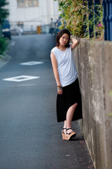 Japanese Girl poses on the street in Yokohama, Japan. Yokohama is a port city located in a bit south of Tokyo.