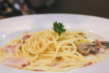 Carbonara pasta with bacon and mushroom.