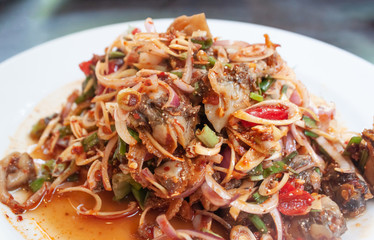 Spicy cockle salad in white plate, Thai seafood