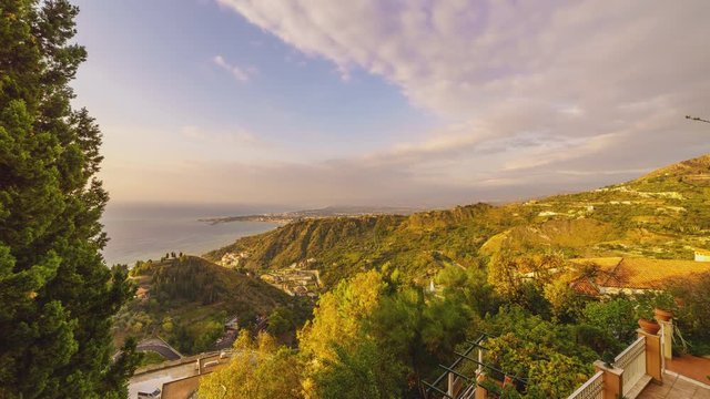 A time lapse of the romantic rolling green hills of Italy with clouds over Mount Etna