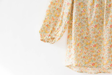 Floral blouse is clothes hanging on white background.close up.