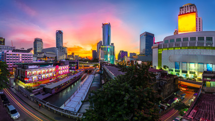 Skyscraper and Pratunam pier in Bangkok; water transportation by speed boat is one of the...