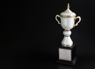 Marble trophy over black background. Winning awards with copy space for text and design.