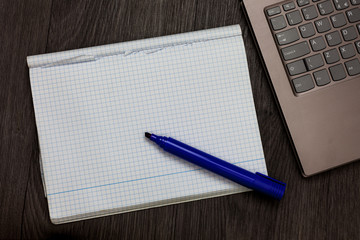 Business Empty template for Layout for invitation greeting card promotion poster voucher. Open notebook squared page black marker computer keyboard wooden background