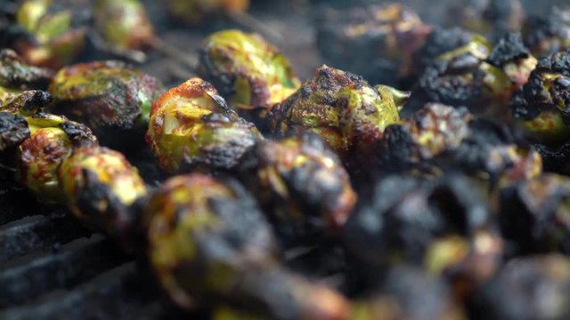 Extreme closeup of brussels sprouts on a hot grill.