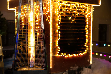 Gas heater on the background of Christmas lights