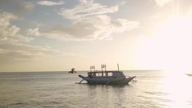 Drone Shot flying over the beautiful boracay island in the philippines at sunset