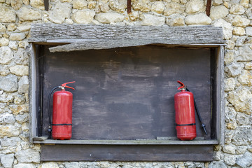 two extinguishers on a black board, place for text. perfect for your security advertising .