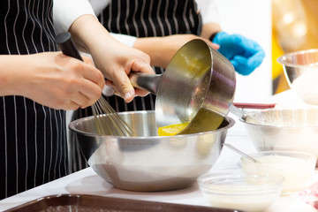 Pastry chef making dough on kitchen, Mixing Buttermilk Pastry Bakery, cookie and cake