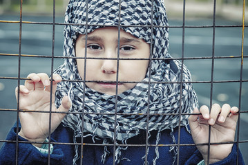 a refugee girl from the east in a headscarf