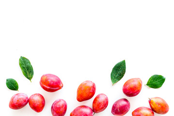 Summer harvest of red plum.  Red plum and leaves pattern on white background top view space for text