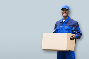 Smiling Male Mover Holding Package
