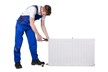 Male Plumber Repairing Thermostat