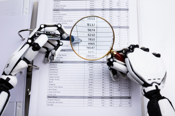 Robotic Hand Examining Financial Data