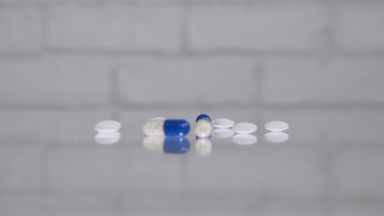 Many Colored Pills on The Table Transparent Surface