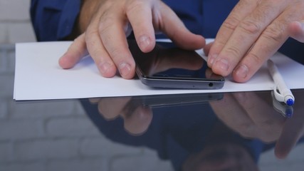 Businessman in Office Reading Smartphone Messages and Emails