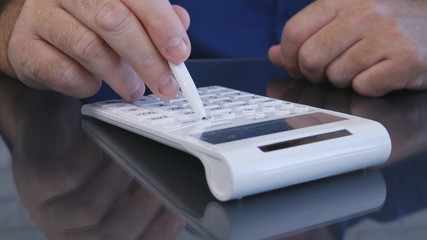 Fototapeta premium Businessman Calculates Using a Pen and Adding Machine