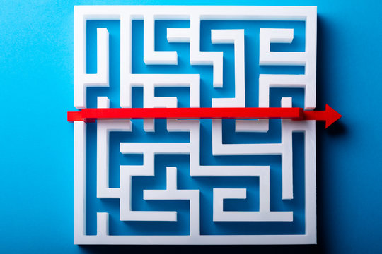 Red Arrow Crossing Over White Maze