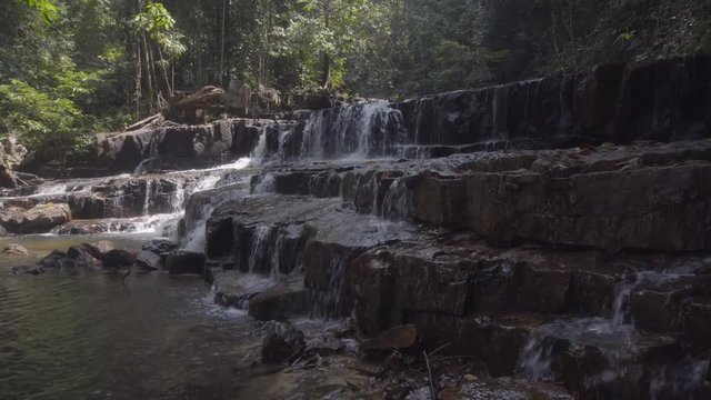 Side wide shot of a waterfall in the rainforest of Jeram Pelangi, Maran, Malaysia