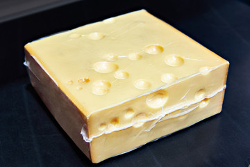 Piece of cheese in vacuum plastic