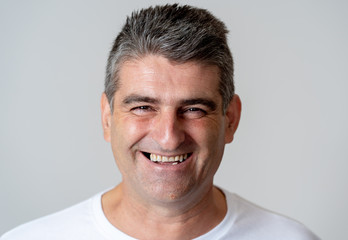 Fototapeta premium Close up portrait of a smiling and laughing mature man in happy face human emotions and expressions