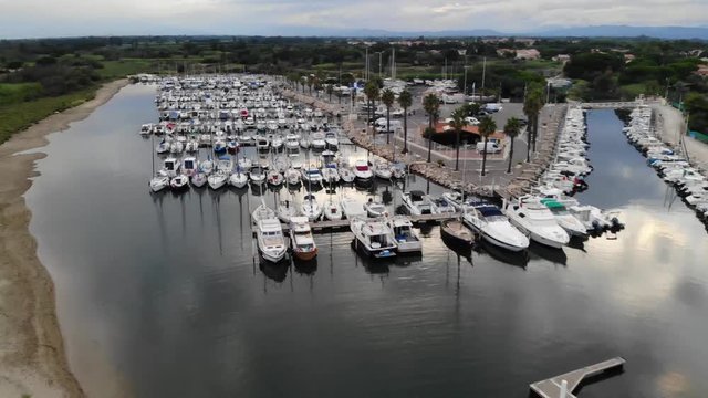 Aerial Drone Footage of the Marina in the Village of Sainte Marie la Mer in the South of France with the Pyrenees-Orientales Mountains in the Background